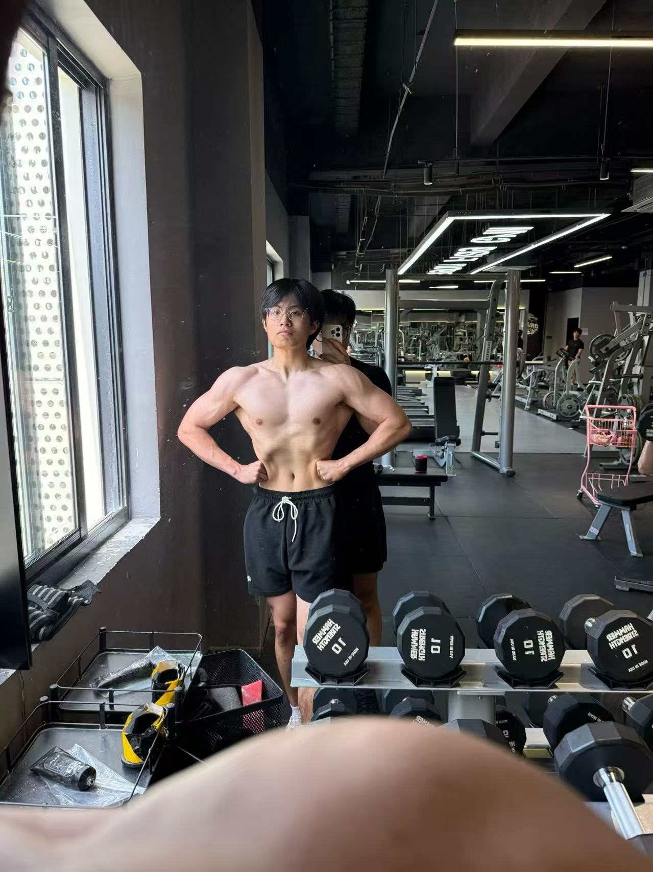 Front physique progress photo in the gym